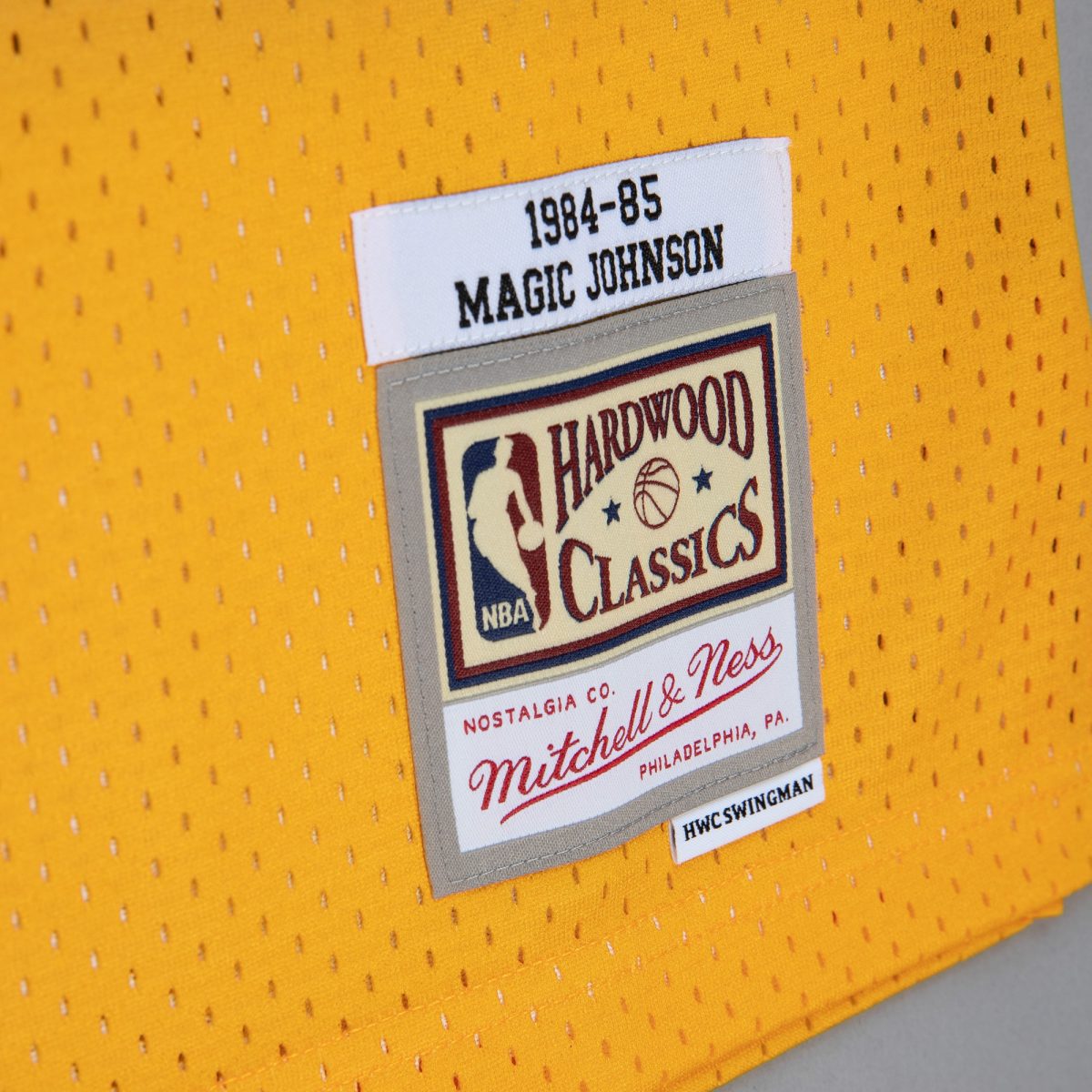 Official Los Angeles Lakers mens los angeles lakers magic johnson mitchell  ness goldpurple 198485 hardwood classics fadeaway swingman player jersey | Lakers Shop